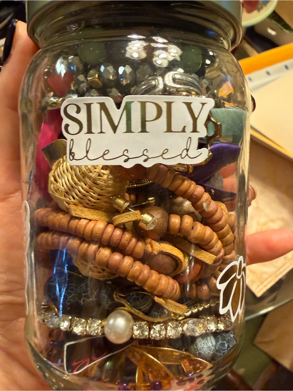 Glass Jar filled with used and brand new jewelry